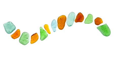 backlit sea glass peices isolated  on white background, shape of a wave