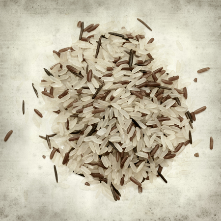 textured old paper background with mixture of different ricesの写真素材