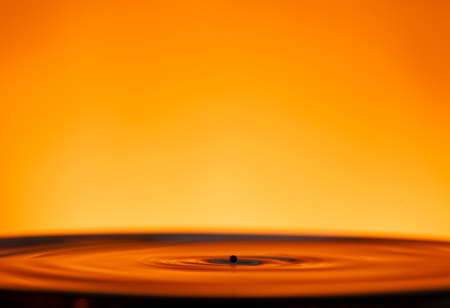 drop of ink falling into liqiud, abstract backgroundの写真素材