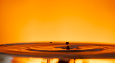 drop of ink falling into liqiud, abstract backgroundの写真素材
