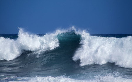 Gran Canaria, foamy waves breaking by the shore in Banaderos area