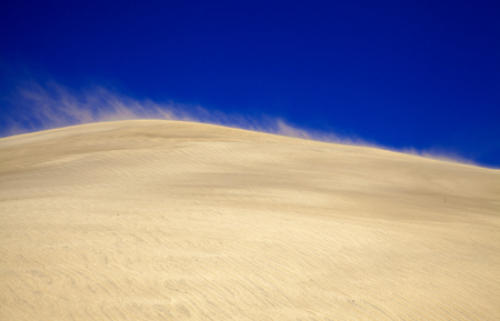 sand and wind pattern on dune surface, sand flying in strong wind, Dunes of Maspalomas, Gran Canariaの写真素材