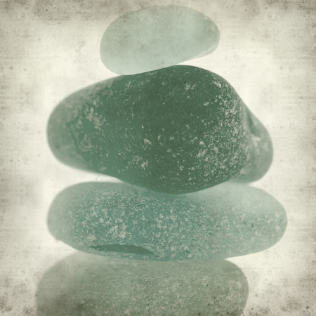 textured old paper background with sea glass pieces