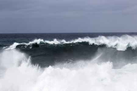 natural background of foamy ocean waves breaking by the shores of Gran Canaria
