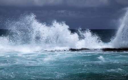 Northern coast of Gran Canaria, natural swimming pools at Playa de Agujero, Galdar municipality, foamy waves breaking at the edge of the poolの写真素材