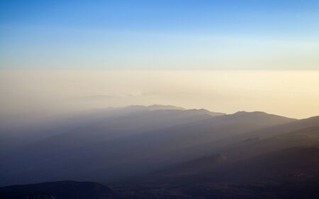 Sunrise on Teide, the tallest mountain of Spain and Atlantic Basin, view north east, Anaga mountain crest with itd cloudfall is visible in far distanceの写真素材