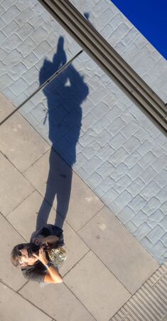 unusual angle photo selfie - photographer aiming camera directly upwards into a mirror roof, dark...