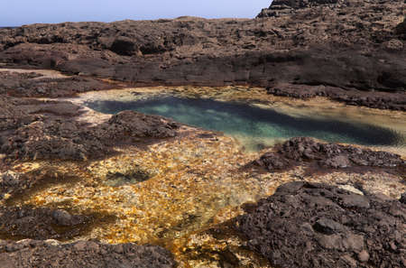Gran Canaria, calm natural seawater pools in under the steep cliffs of the north coast, separated from the ocean by 
volcanic rock, Punta de Galdar areaの写真素材
