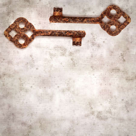 stylish textured old paper background with old rusty keyの写真素材