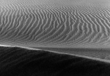 natural sand pattern created by wind blowing differently sized and colored particlesの写真素材