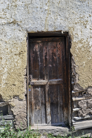 Old door on a semi collapsed rural homeの写真素材