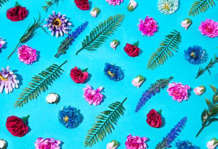 Spring flowers decorated on a blue table. Flower pattern. Blue background. Colorful flowers.の写真素材