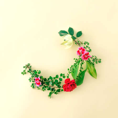 A wreath of flowers as a frame. Place for text. Flowers on the table.の写真素材