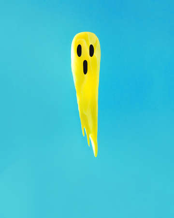 Yellow ghost for Halloween made of paint. Minimal fun spooky concept during the holidays. Autumn...