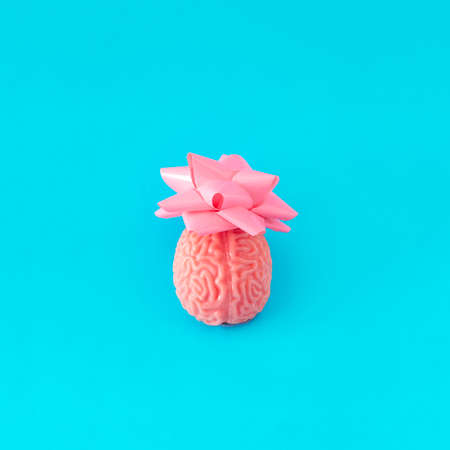 Brain as a gift. Minimal funny composition on blue backgrounds.