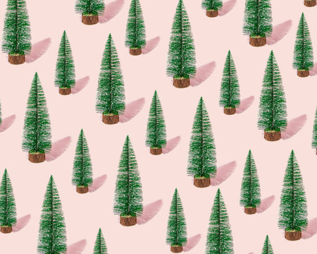 Pattern of Christmas trees on a pink background. Minimal trend Holidays idea.の写真素材