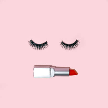 Creative trendy idea of a woman's face with eyelashes and red lipstick. Minimal fashion makeup and cosmetic concept.の写真素材