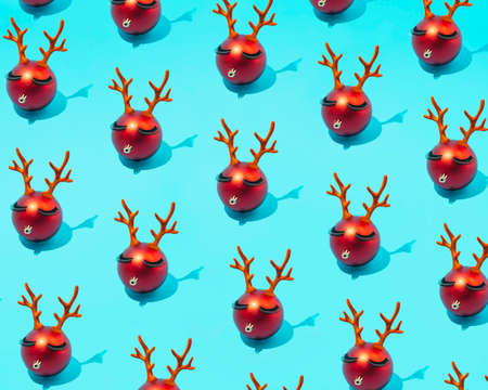 Trendy reindeer pattern with lashes made of Christmas decorations on a sky blue background. Make up aesthetics and New Year's concept.の写真素材