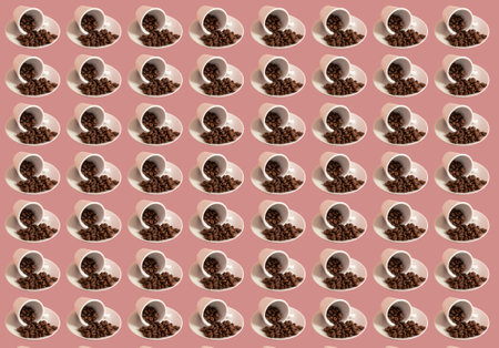 Pattern of cups filled with coffee grains, on the side, on pink background.の写真素材