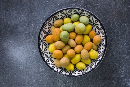 Nuts in bowls on the table, almonds, cashews and coasted nuts on the blue background. Colorful nuts...