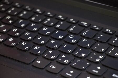 Laptop and notebook computer keyboard close-up, texts, keys and black board. Low angle view.の写真素材