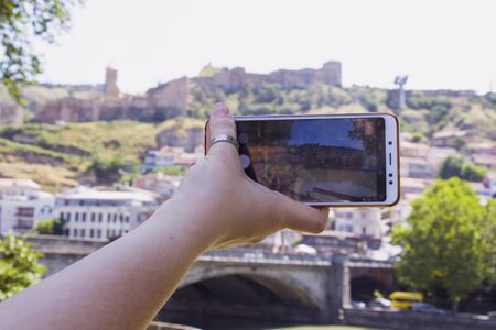 Woman hand and mobile phone, video and photo shooting scene, tourist and traveler take photo and...