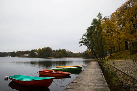 Old wooden boats near the beach of Trakai Gavle lake , Lithuania. Autumn and fall time.の写真素材