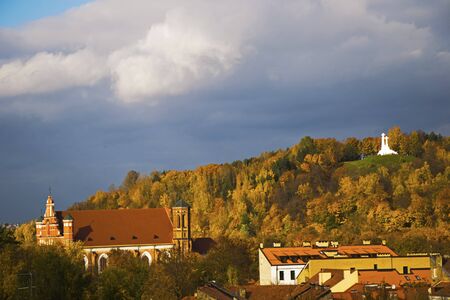 City view and city scape of Vilnius, Lithuania. Three crosses and autumn forest. Church and old buildings.の写真素材