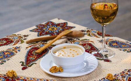 Walnut sauce in the bowl on the table with white wine and walnuts, ready to eat.の写真素材