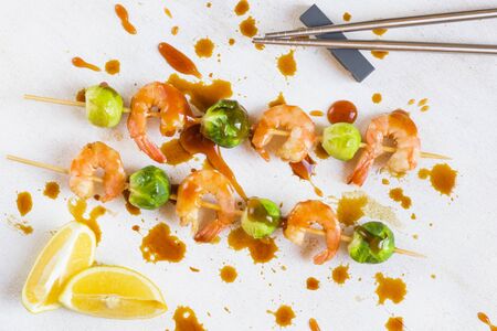 Shrimps and cabbage kebab with souse and lemon, on the table, studio shot. Seafood photography.の写真素材