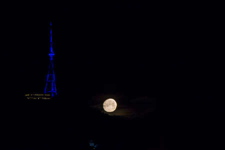 TBILISI, GEORGIA - FEBRUARY 18, 2019: city view at night, moon and TV tower in Tbilisi, Georgia.のeditorial素材