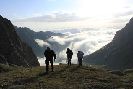 People mountaineering and hiking in Georgia, Mountain landscape and Georgian nature. Travel destination. Young people trekking in the mountain.の写真素材