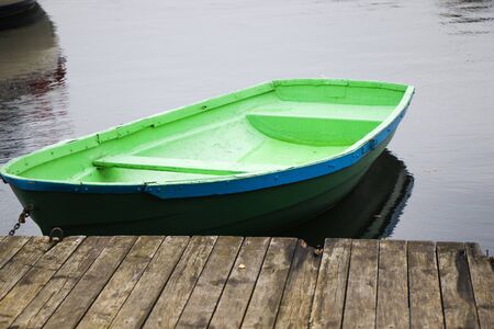 Old wooden boats near the beach of Trakai Gavle lake lake, Lithuania. Autumn and fall time.の写真素材