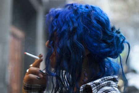 TBILISI, GEORGIA - APRIL 13, 2018: Girl with blue hair portrait, young woman on the street.の写真素材