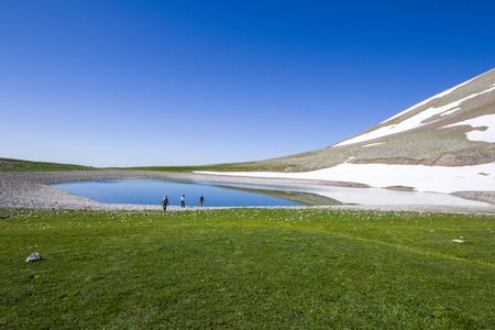 Mountain lake landscape and hikers in Georgiaの写真素材
