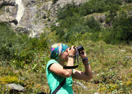 Young women take photo, hiker in the mountains shooting landscape