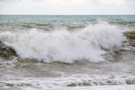 Stormy wheater, waves and splashes in Batumi, Georgia. Stormy Black sea. Water background.