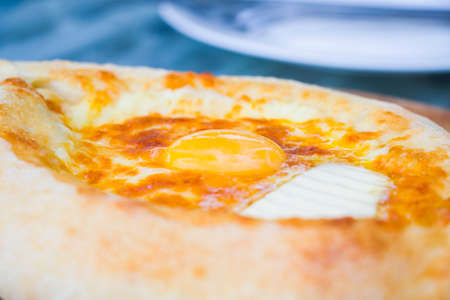 Adjaruli khachapuri close-up, Georgian traditional food, cuisine and gastronomy in Batumi, Georgia....