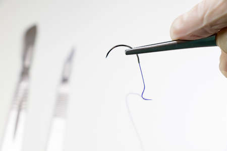 Dissection Kit - Absorbable suture, polyglycolic acid. Surgery operation equipment, knife, needle and suture. Studio shoot.の写真素材