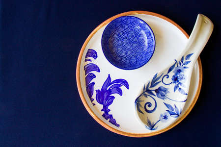 Empty blue tableware, bowl and plate on the blue table. Dish set. Table setting.