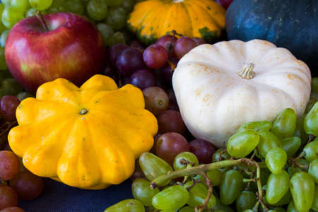 Autumn and fall harvest, pumpkin, apple, grape and pattison on the blue backgroundの写真素材