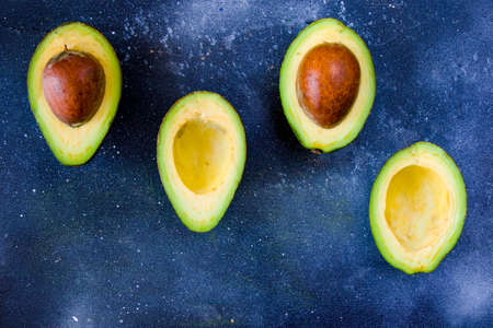 Half avocado on the blue background, vegetable and fruitの写真素材