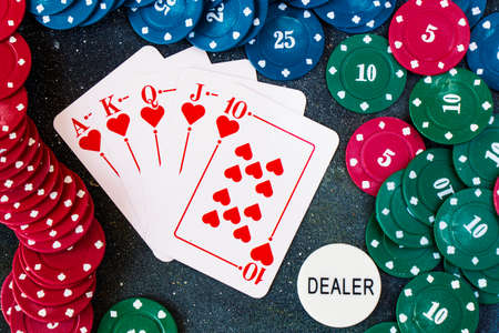 TBILISI, GEORGIA - SEPTEMBER 18, 2020: Royal flash poker and blackjacks cards on the dark backgroundの写真素材