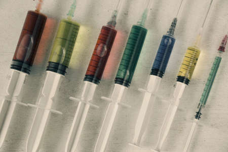 Multicolored and colorful medical needle with chemical drugs and vaccineの写真素材