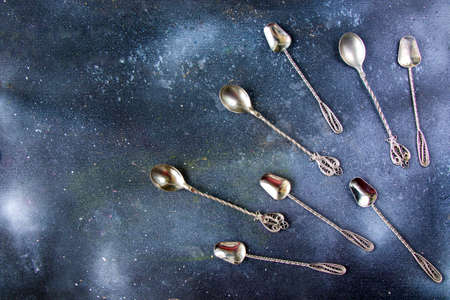 Silverware, silver vintage spoon background, spoon set on the dark background