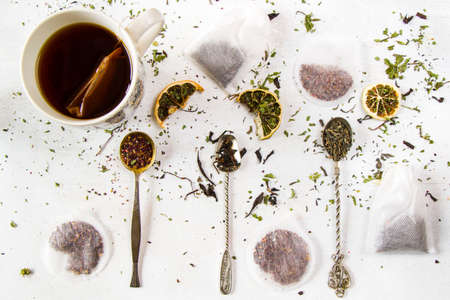 Set of tea on the vintage silverware spoons, various of tea and cup of teaの写真素材