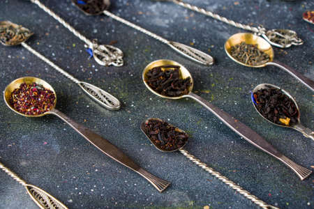 Set of tea on the vintage silverware spoons, various of tea, black, flower, green and mint teaの写真素材