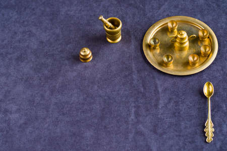 Golden vintage miniature dishware on the table, small objectsの写真素材
