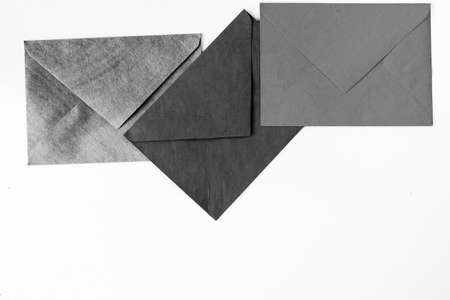 Three envelope on the white background, black and white photoの写真素材