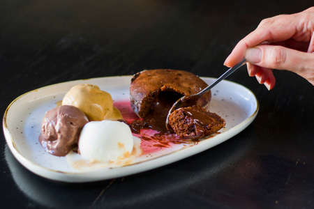 Dessert with ice cream and volcano cupcake on the plate in restaurant
